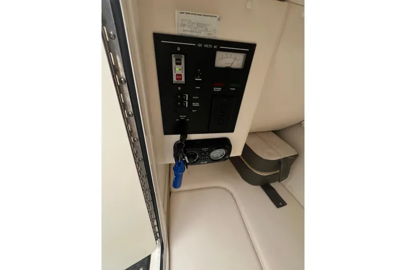 Slide: The Image of Control panel inside 2011 Sea Ray 300 Sundeck boat, featuring switches and gauges. - 7