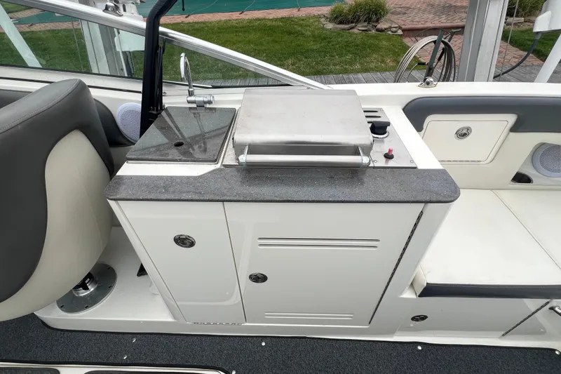 Slide: The Image of 2011 Sea Ray 300 Sundeck boat interior with sink and grill station. - 8