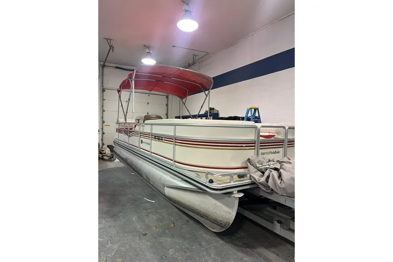 The Image of 2002 Harris FloteBote 220 Super Sunliner pontoon boat in indoor storage. - 1