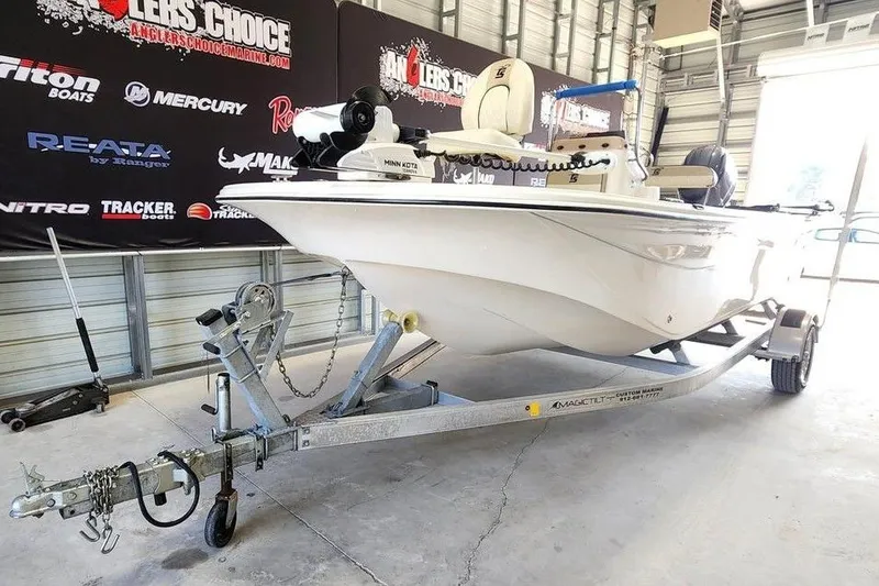 Slide: The Image of 2021 Carolina Skiff 19 LS boat on trailer in showroom with branded backdrop. - 4