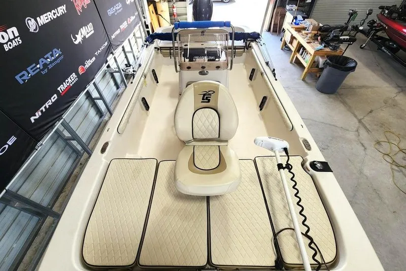 Slide: The Image of 2021 Carolina Skiff 19 LS boat interior with seating and fishing equipment in a garage. - 5
