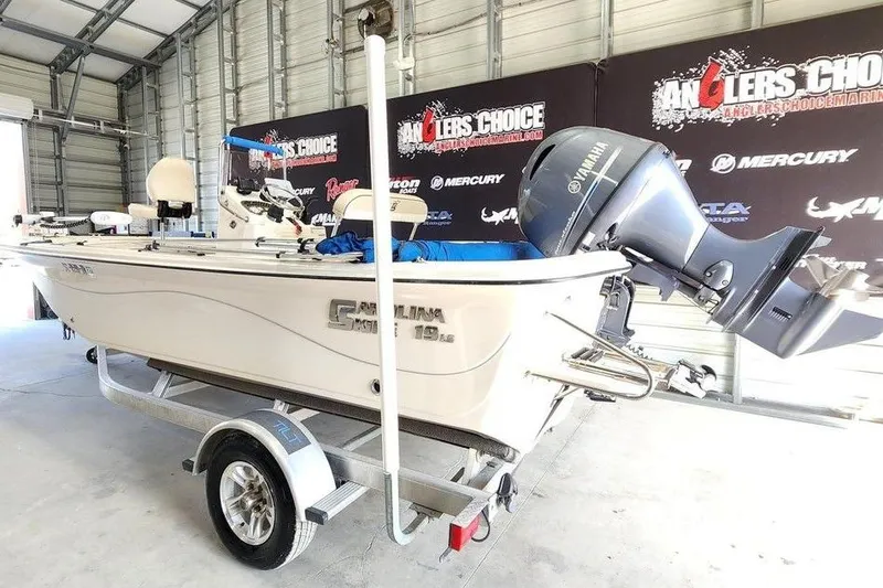Slide: The Image of 2021 Carolina Skiff 19 LS boat on trailer in showroom with Yamaha outboard motor. - 6