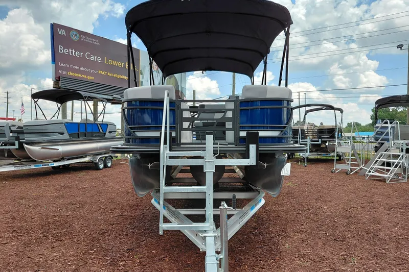 Slide: The Image of 2026 Starcraft EXS 1 Q DH pontoon boat on display under a cloudy sky. - 10