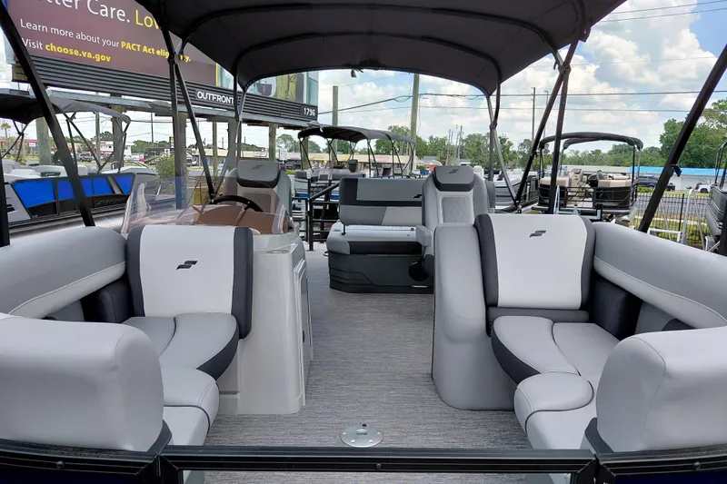 Slide: The Image of 2026 Starcraft EXS 1 Q DH pontoon boat interior with plush seating and canopy. - 11