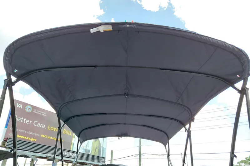 Slide: The Image of 2026 Starcraft EXS 1 Q DH boat canopy against a bright sky background. - 12