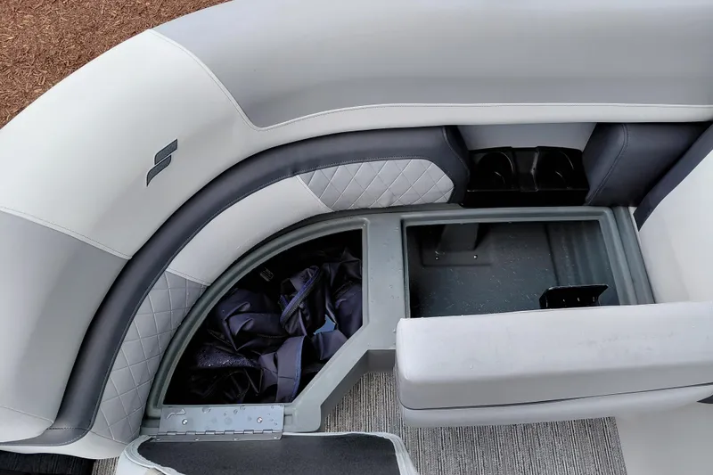 Slide: The Image of 2026 Starcraft EXS 1 Q DH boat interior with storage compartment and cushioned seating. - 17