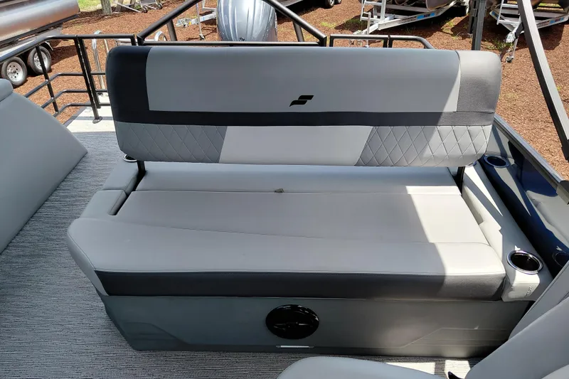 Slide: The Image of 2026 Starcraft EXS 1 Q DH boat interior with gray cushioned seating and cup holders. - 28