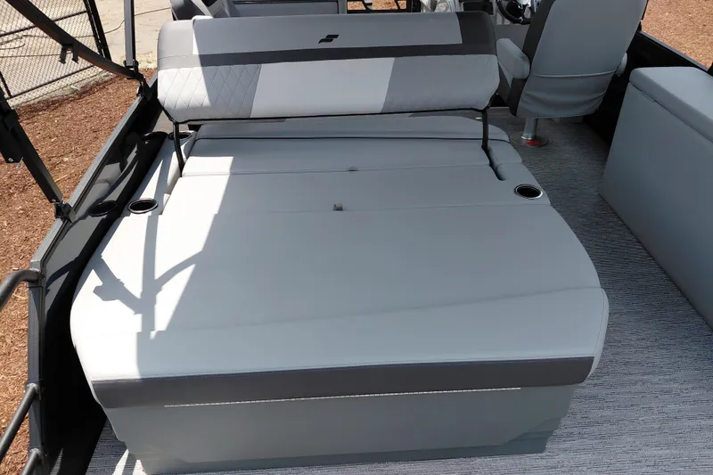 Slide: The Image of 2026 Starcraft EXS 1 Q DH boat interior with convertible seating and cup holders. - 32