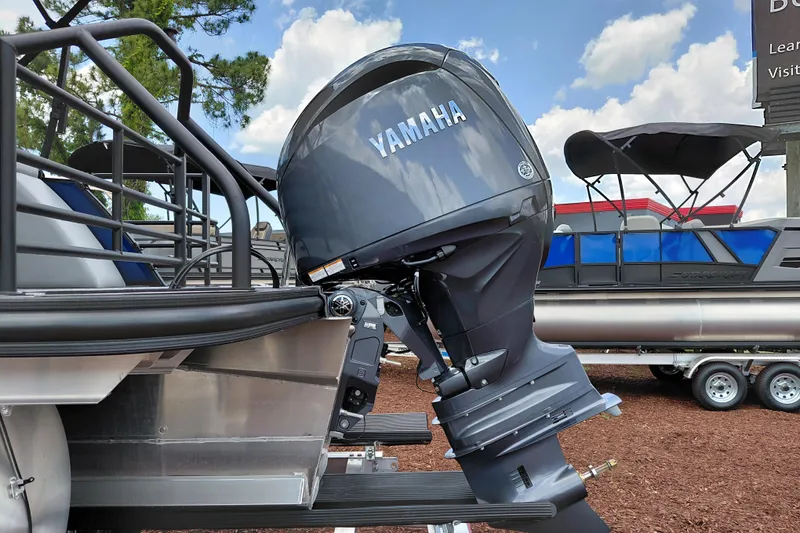 Slide: The Image of 2026 Starcraft EXS 1 Q DH boat with Yamaha outboard motor, parked on a trailer. - 5