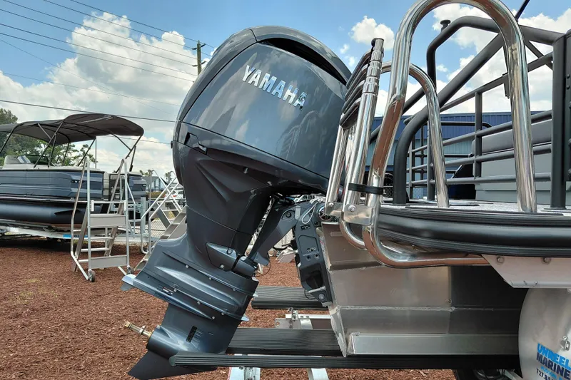 Slide: The Image of 2026 Starcraft EXS 1 Q DH boat with Yamaha outboard motor, displayed outdoors. - 6
