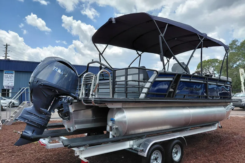 Slide: The Image of 2026 Starcraft EXS 1 Q DH pontoon boat with Yamaha outboard motor on trailer. - 7