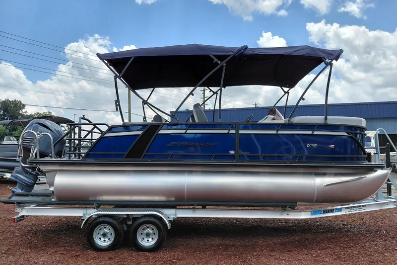 Slide: The Image of 2026 Starcraft EXS 1 Q DH pontoon boat with canopy on trailer. - 8