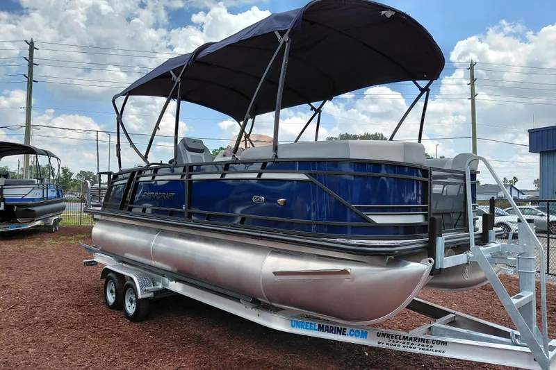 Slide: The Image of 2026 Starcraft EXS 1 Q DH pontoon boat on trailer, under blue sky. - 9