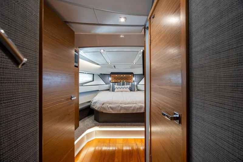 Slide: The Image of Luxurious cabin interior of 2022 Tiara Yachts 43 LE, featuring elegant wood finishes and modern design. - 10