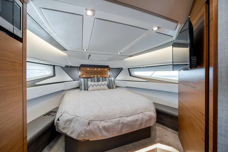 Slide: The Image of Luxurious cabin interior of 2022 Tiara Yachts 43 LE with modern design and cozy bedding. - 11