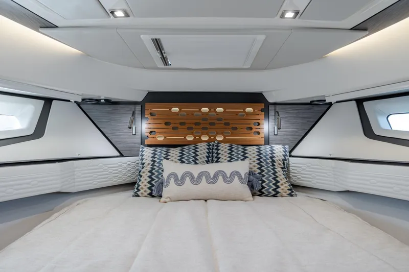 Slide: The Image of Luxurious interior of 2022 Tiara Yachts 43 LE, featuring elegant bedding and modern design. - 12
