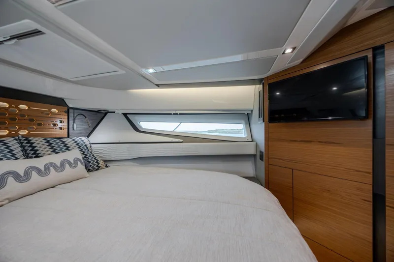 Slide: The Image of Luxurious 2022 Tiara Yachts 43 LE cabin interior with modern design and cozy bedding. - 13