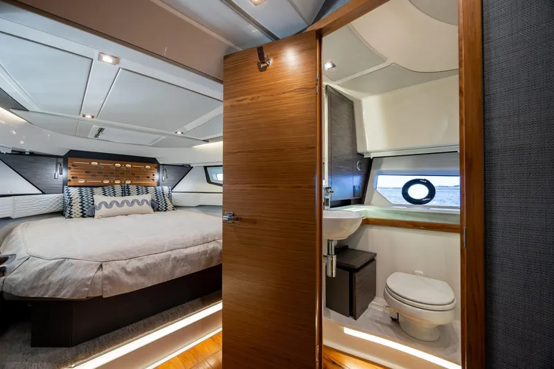 Slide: The Image of Luxurious 2022 Tiara Yachts 43 LE cabin interior with bed and bathroom. - 17