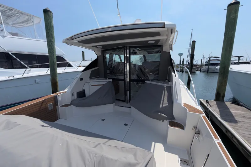Slide: The Image of 2022 Tiara Yachts 43 LE docked, showcasing spacious deck and sleek design. - 2