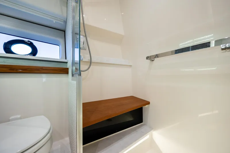 Slide: The Image of 2022 Tiara Yachts 43 LE bathroom interior with modern fixtures and wooden accents. - 21