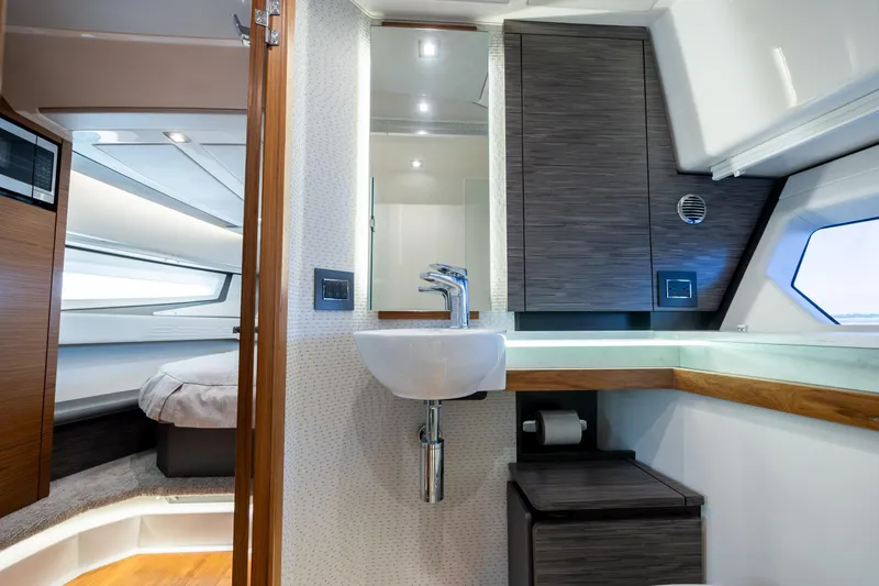 Slide: The Image of Luxurious 2022 Tiara Yachts 43 LE interior with modern bathroom and cozy sleeping area. - 22