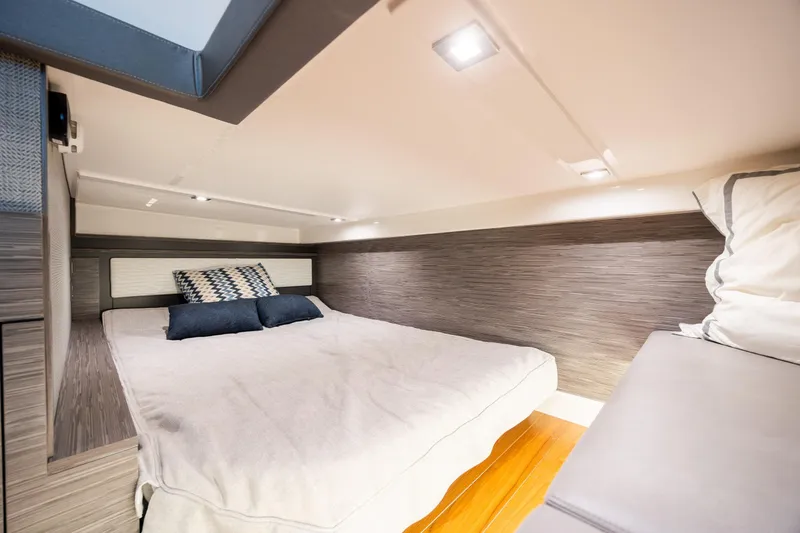 Slide: The Image of Luxurious cabin interior of 2022 Tiara Yachts 43 LE with modern bedding. - 25