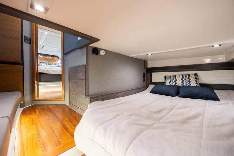 Slide: The Image of Luxurious interior cabin of 2022 Tiara Yachts 43 LE with elegant bedding and wood flooring. - 26