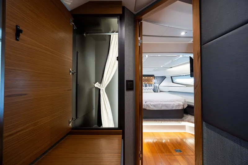 Slide: The Image of Luxurious interior of 2022 Tiara Yachts 43 LE, featuring a cozy bedroom and elegant wood finishes. - 27