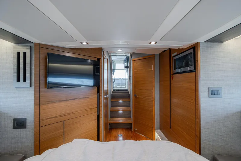 Slide: The Image of Interior of 2022 Tiara Yachts 43 LE, featuring wood paneling, TV, and microwave. - 29