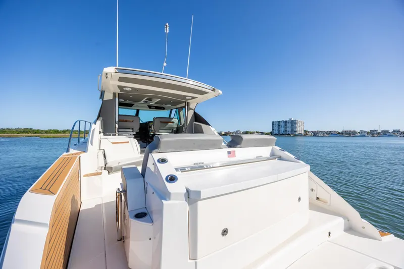 Slide: The Image of 2022 Tiara Yachts 43 LE on serene water, showcasing luxury design and spacious deck. - 32