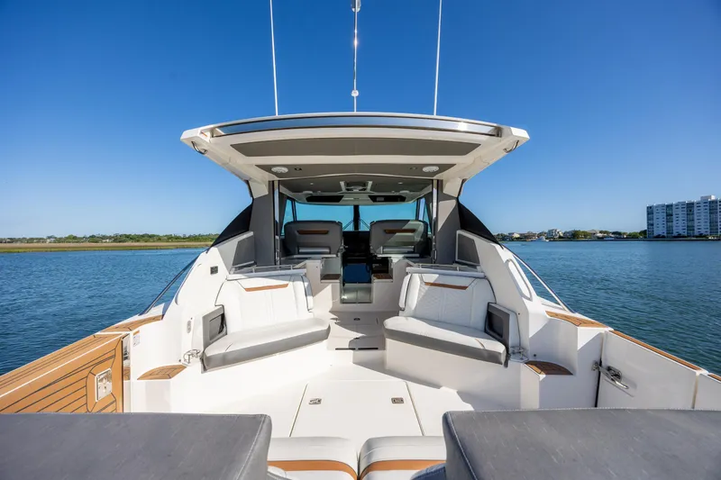 Slide: The Image of 2022 Tiara Yachts 43 LE luxury yacht interior with seating, on calm water. - 35