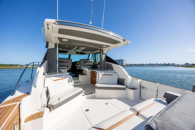 Slide: The Image of 2022 Tiara Yachts 43 LE luxury boat interior with seating, on a sunny day by the water. - 36