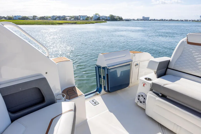 Slide: The Image of 2022 Tiara Yachts 43 LE luxury seating area with scenic waterfront view. - 38