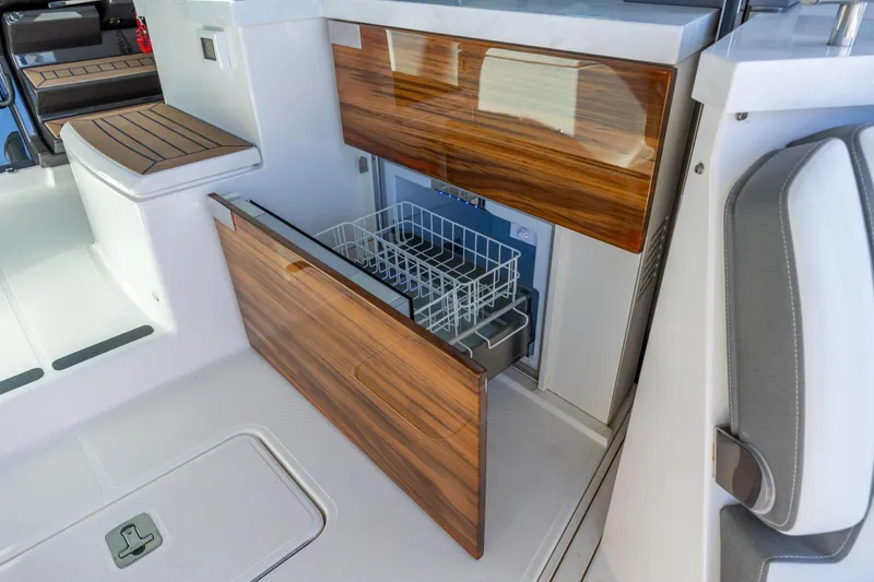 Slide: The Image of Luxury interior of 2022 Tiara Yachts 43 LE with built-in dishwasher and elegant wood finish. - 44