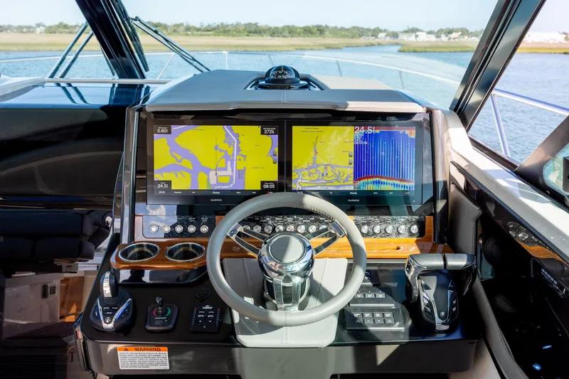 Slide: The Image of 2022 Tiara Yachts 43 LE helm with dual navigation screens and modern controls. - 46