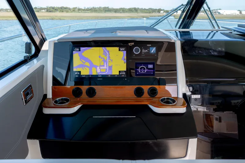 Slide: The Image of Tiara Yachts 43 LE 2022 dashboard with navigation display and controls. - 47