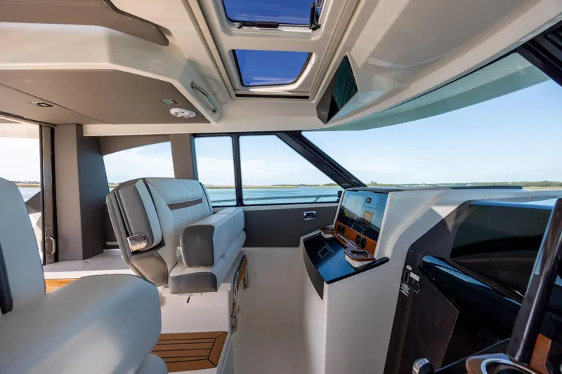 Slide: The Image of Interior of 2022 Tiara Yachts 43 LE, featuring modern helm and luxurious seating. - 49