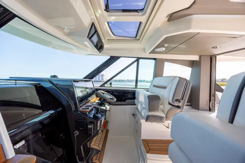 Slide: The Image of Interior of 2022 Tiara Yachts 43 LE, featuring modern helm and luxurious seating. - 50