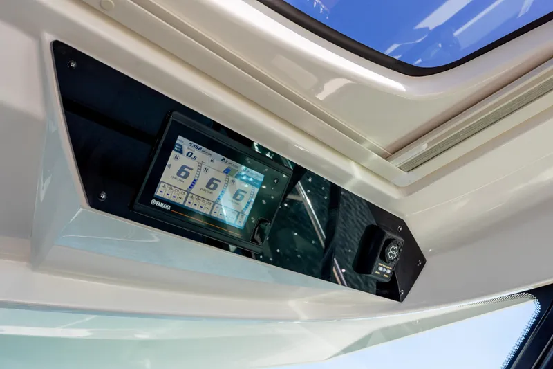 Slide: The Image of 2022 Tiara Yachts 43 LE dashboard with Yamaha display and controls. - 51