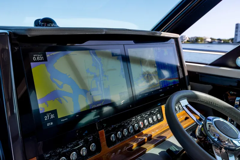 Slide: The Image of Dashboard of 2022 Tiara Yachts 43 LE with navigation screens and steering wheel. - 53