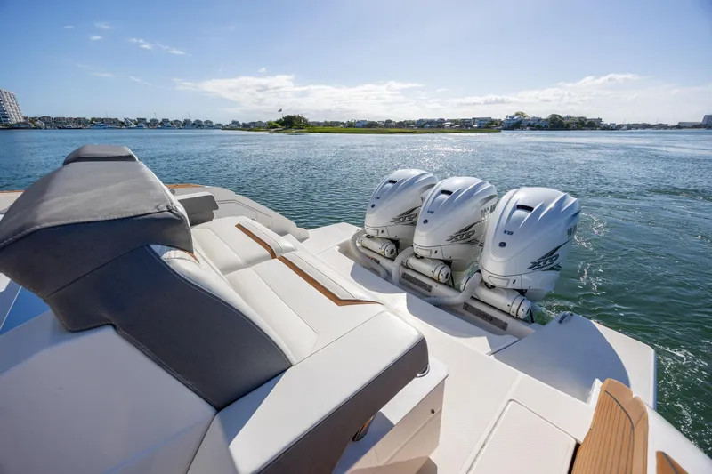 Slide: The Image of 2022 Tiara Yachts 43 LE with triple outboard engines on a sunny day. - 54