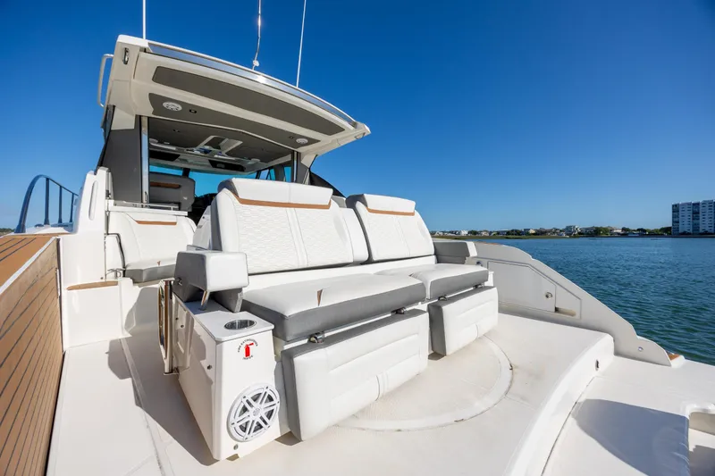 Slide: The Image of 2022 Tiara Yachts 43 LE luxury yacht with spacious seating, docked by calm waters. - 56
