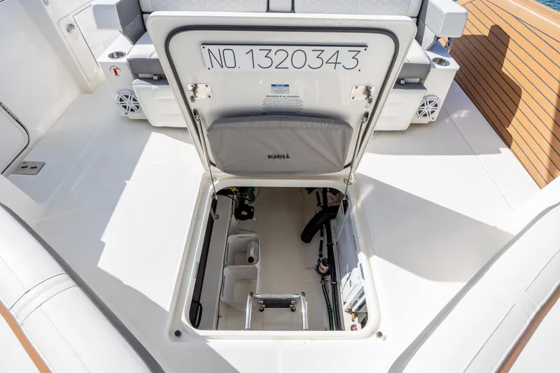 Slide: The Image of Open hatch on 2022 Tiara Yachts 43 LE, revealing storage compartment and equipment. - 57