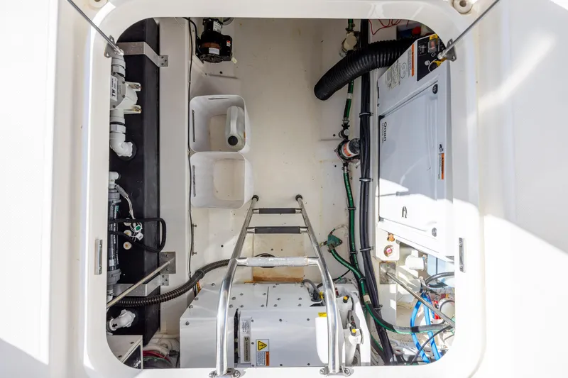 Slide: The Image of Engine compartment of 2022 Tiara Yachts 43 LE, showcasing mechanical components and wiring. - 58