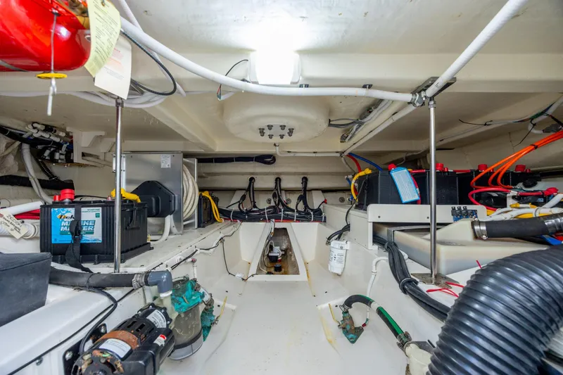 Slide: The Image of Engine room of 2022 Tiara Yachts 43 LE, showcasing batteries and wiring. - 59