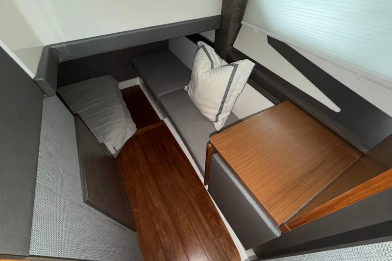 Slide: The Image of 2022 Tiara Yachts 43 LE interior cabin with modern seating and wooden accents. - 6