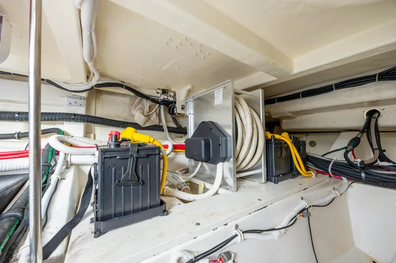 Slide: The Image of Engine room of 2022 Tiara Yachts 43 LE, showcasing wiring and battery setup. - 60