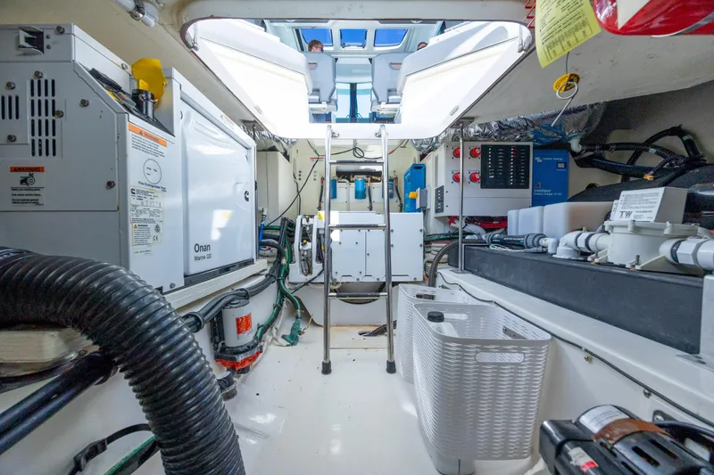 Slide: The Image of Engine room of 2022 Tiara Yachts 43 LE, featuring Onan Marine generator and advanced equipment. - 61