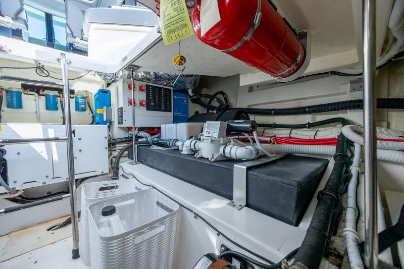 Slide: The Image of Engine room of 2022 Tiara Yachts 43 LE, featuring equipment and wiring. - 63