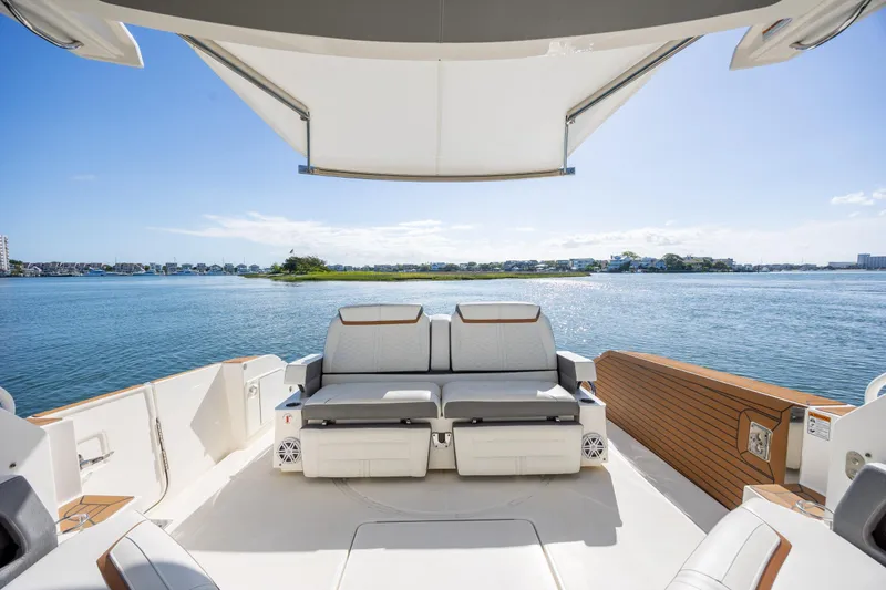 Slide: The Image of Luxurious 2022 Tiara Yachts 43 LE with spacious deck overlooking serene waters. - 66
